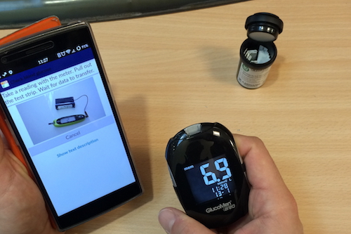 The GDm-Health app is designed to improve gestational diabetes management. Image shows a smartphone linked by Bluetooth to a blood glucose meter.