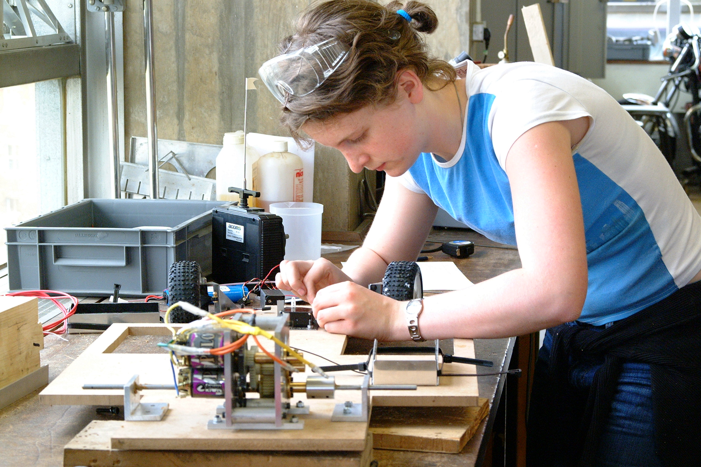 Young student in lab workshop working on electrical engineering project