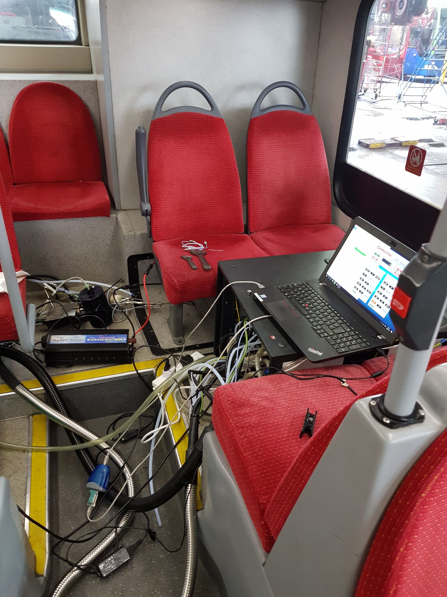 Laptop inside bus attached to various sensors used to measure NOx emissions on key routes