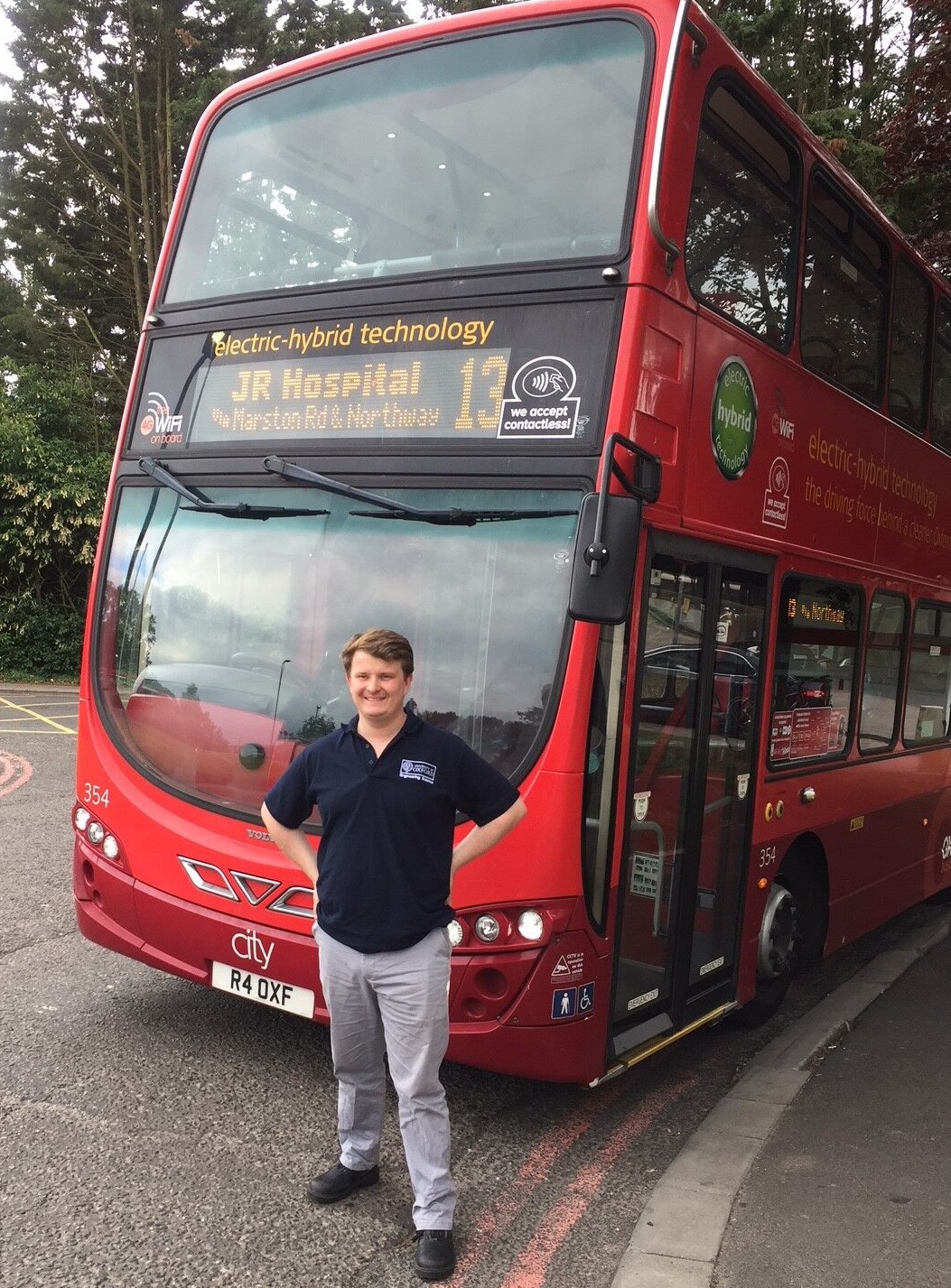 Professor Felix Leach standing in front of Oxford Bus Company no.13 bus used in the study
