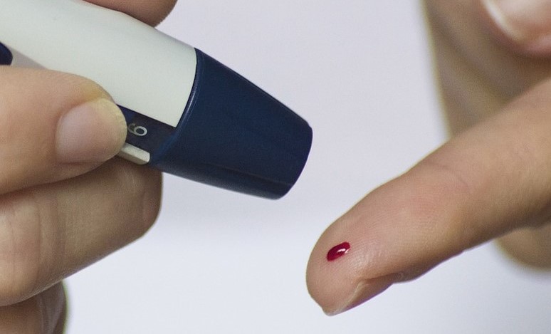Stock image of finger prick blood test