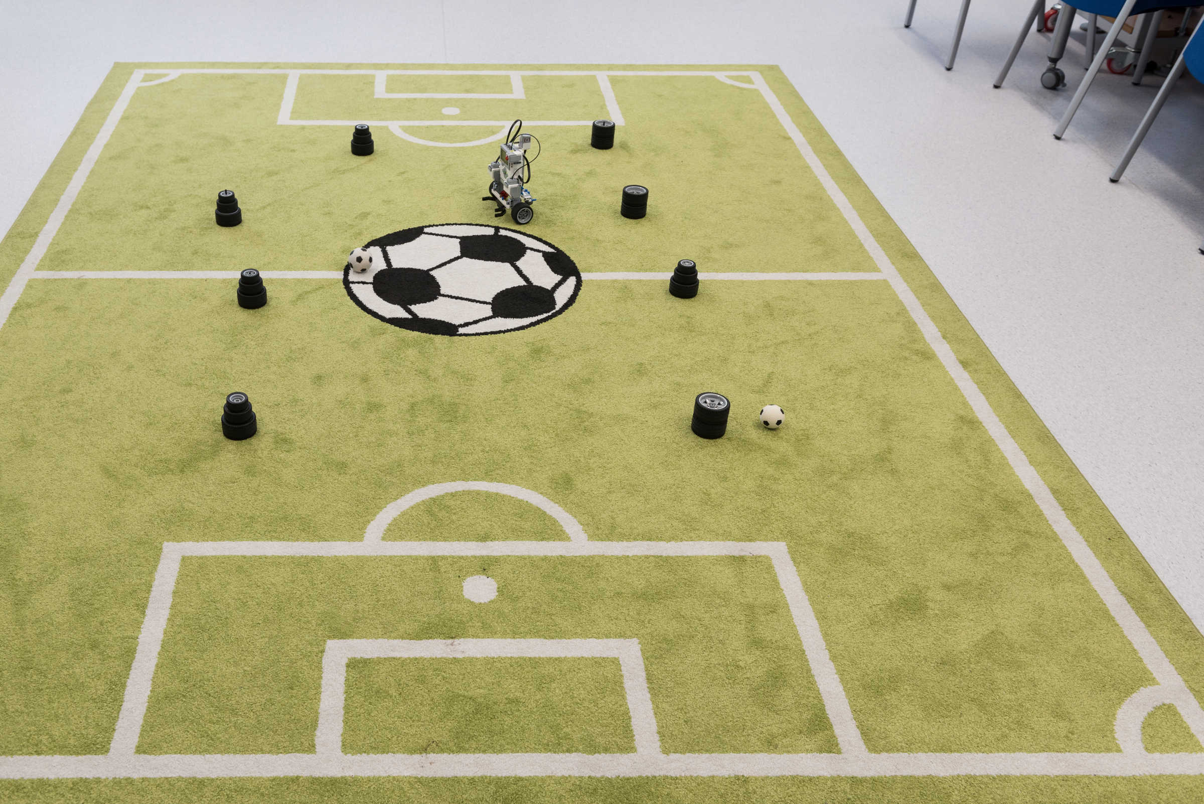 Very small robot on a miniature football pitch