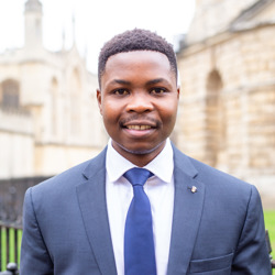 Young man smiling in suit