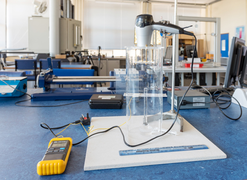 Lab equipment set up with hair dryer pointing at lab bench