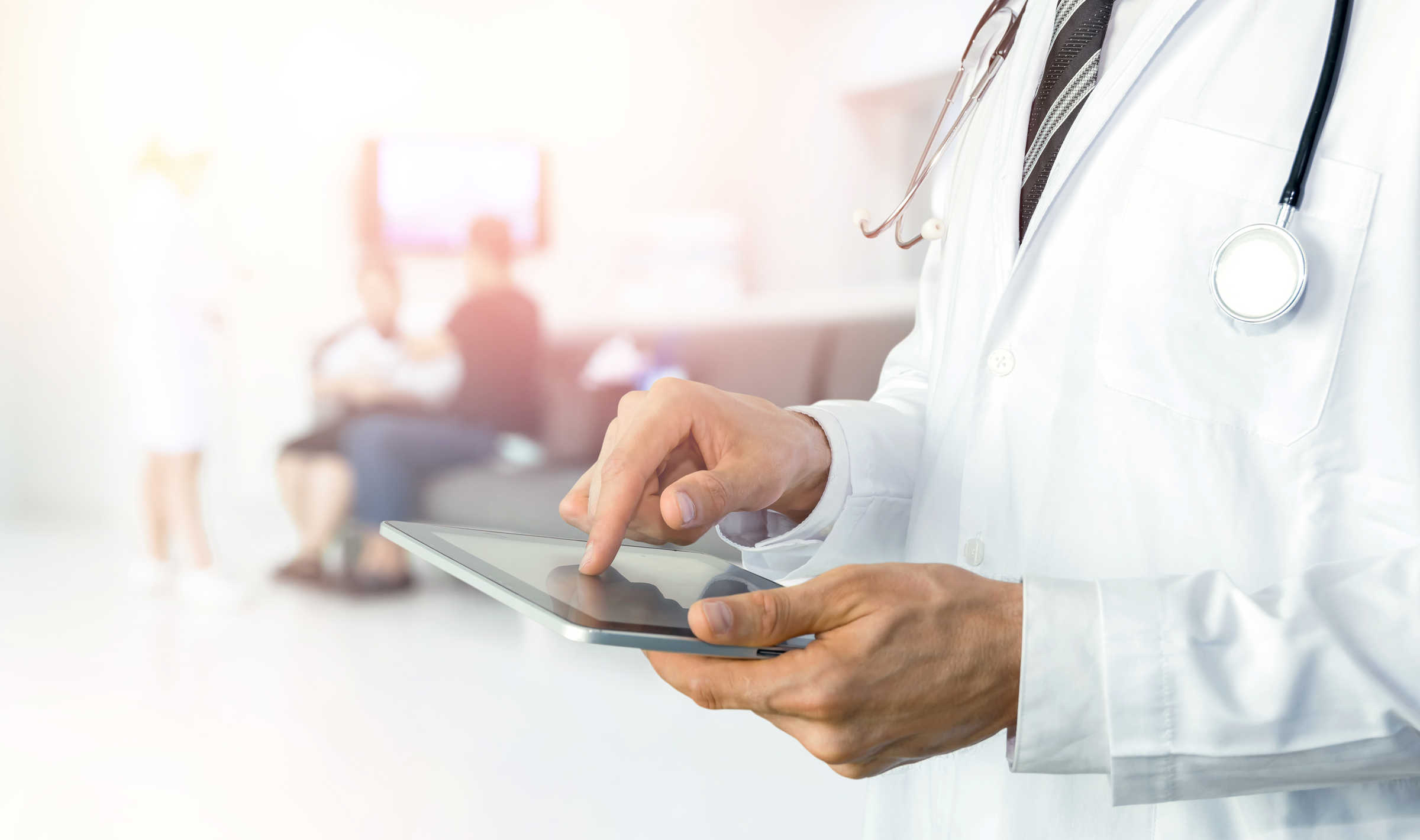Stock image of medical professional using a tablet