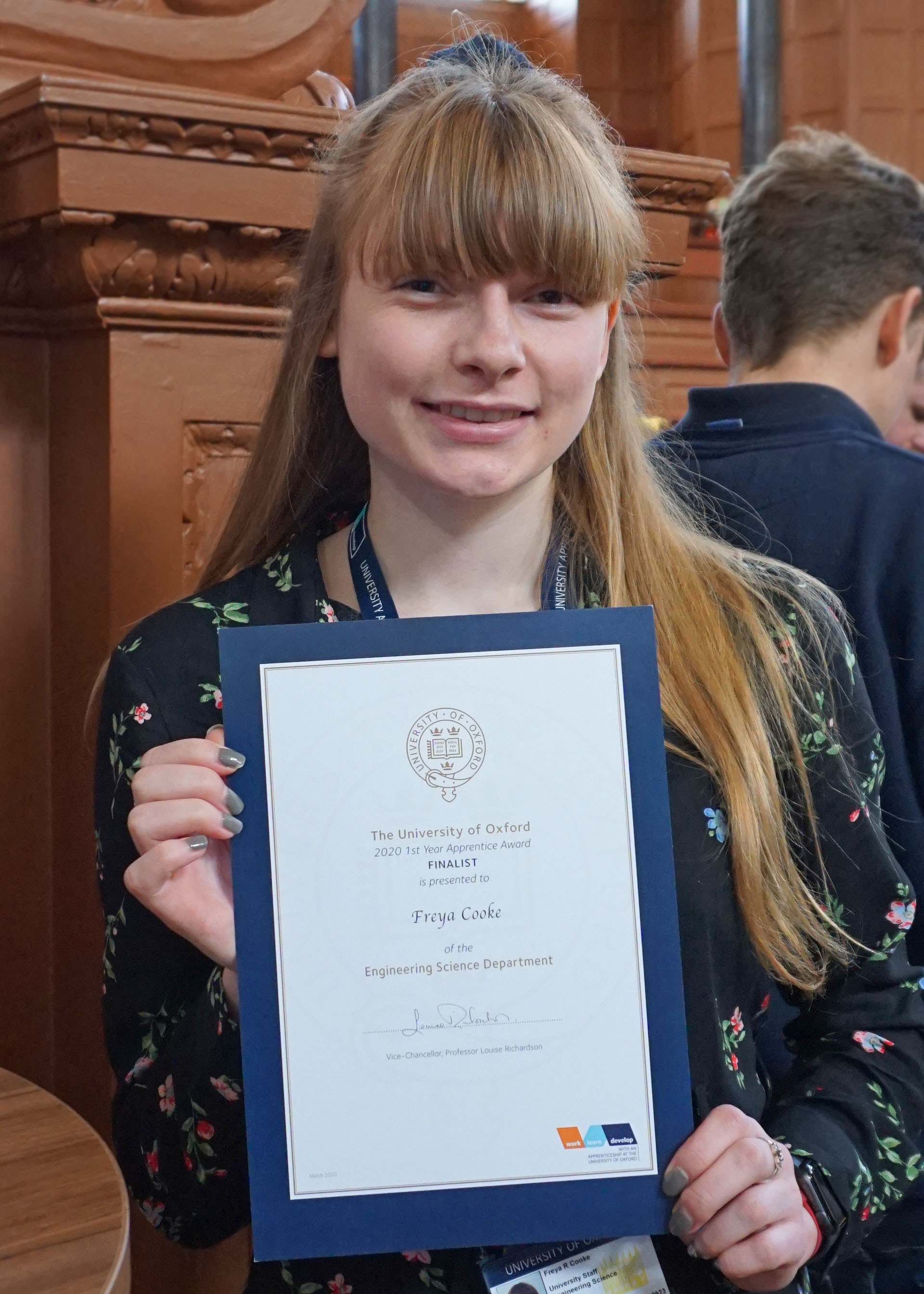 Freya Cook, Apprentice Finance Assistant, holds up her certificate as finalist in the 1st Year category