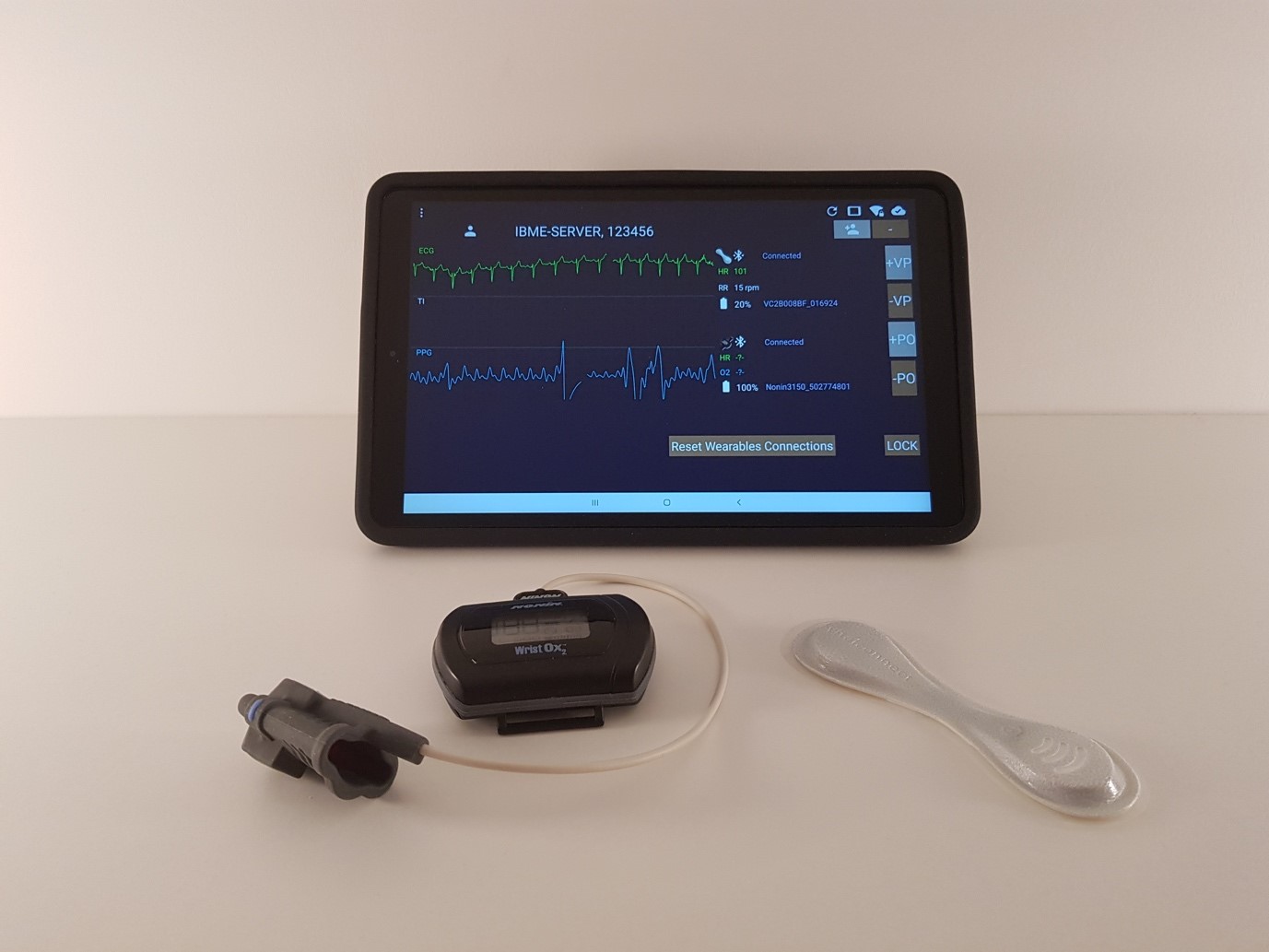 A wearable patch (to measure respiratory rate) and wrist-worn pulse oximeter (to measure pulse rate and oxygen saturation), are linked by Bluetooth to a tablet computer