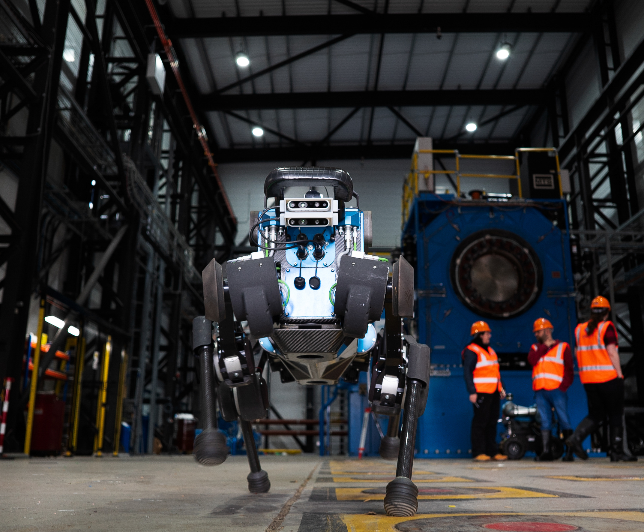 blue ANYmal B robot, standing in industrial site. 