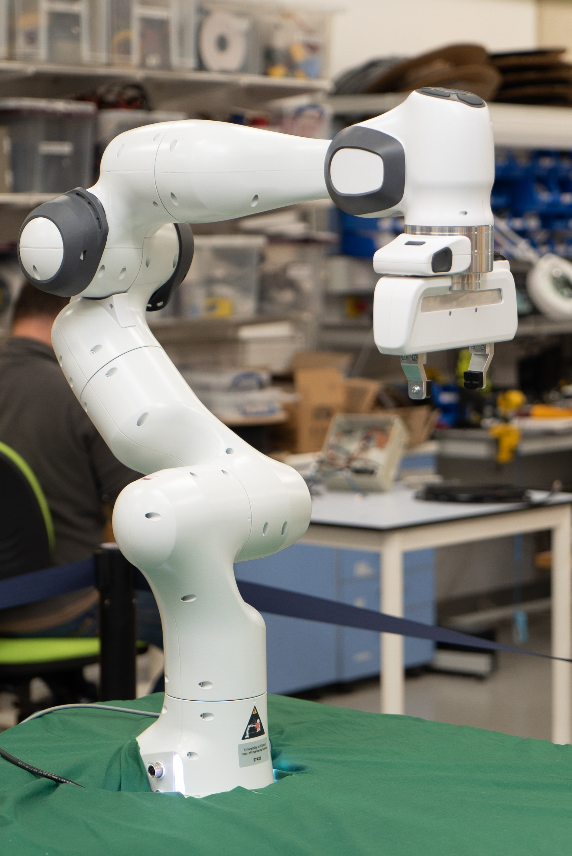 Panda robot arm on green table. 