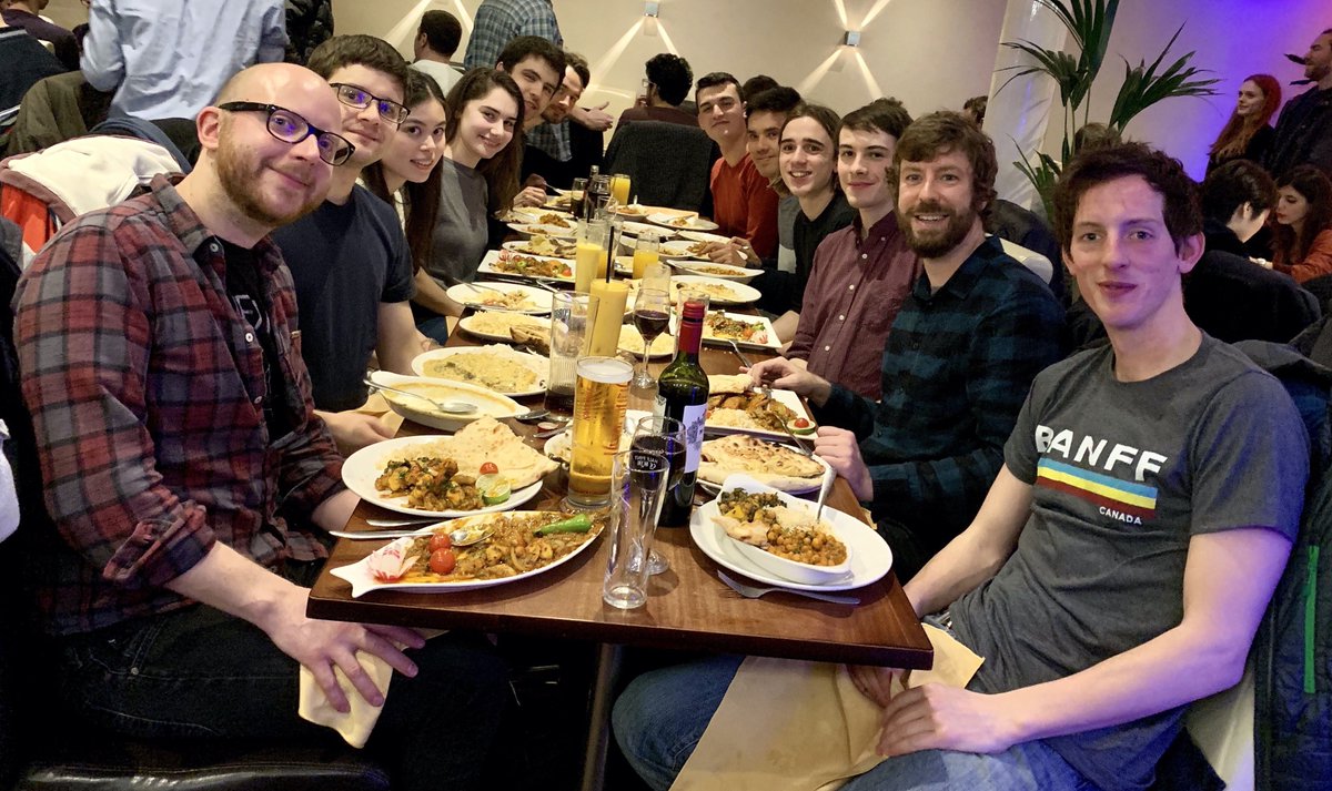GOALS group sitting at dinner table for group outing. 