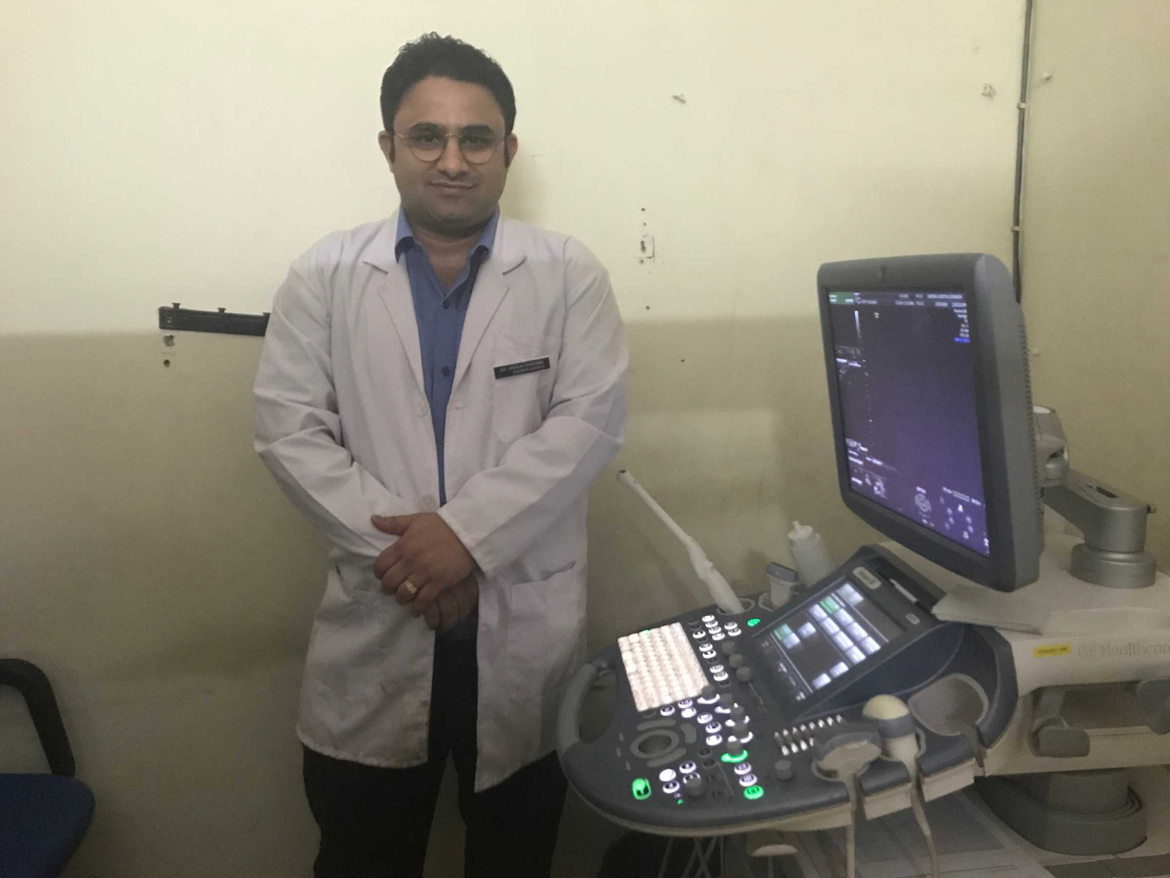 Medical professional next to ultrasound machine