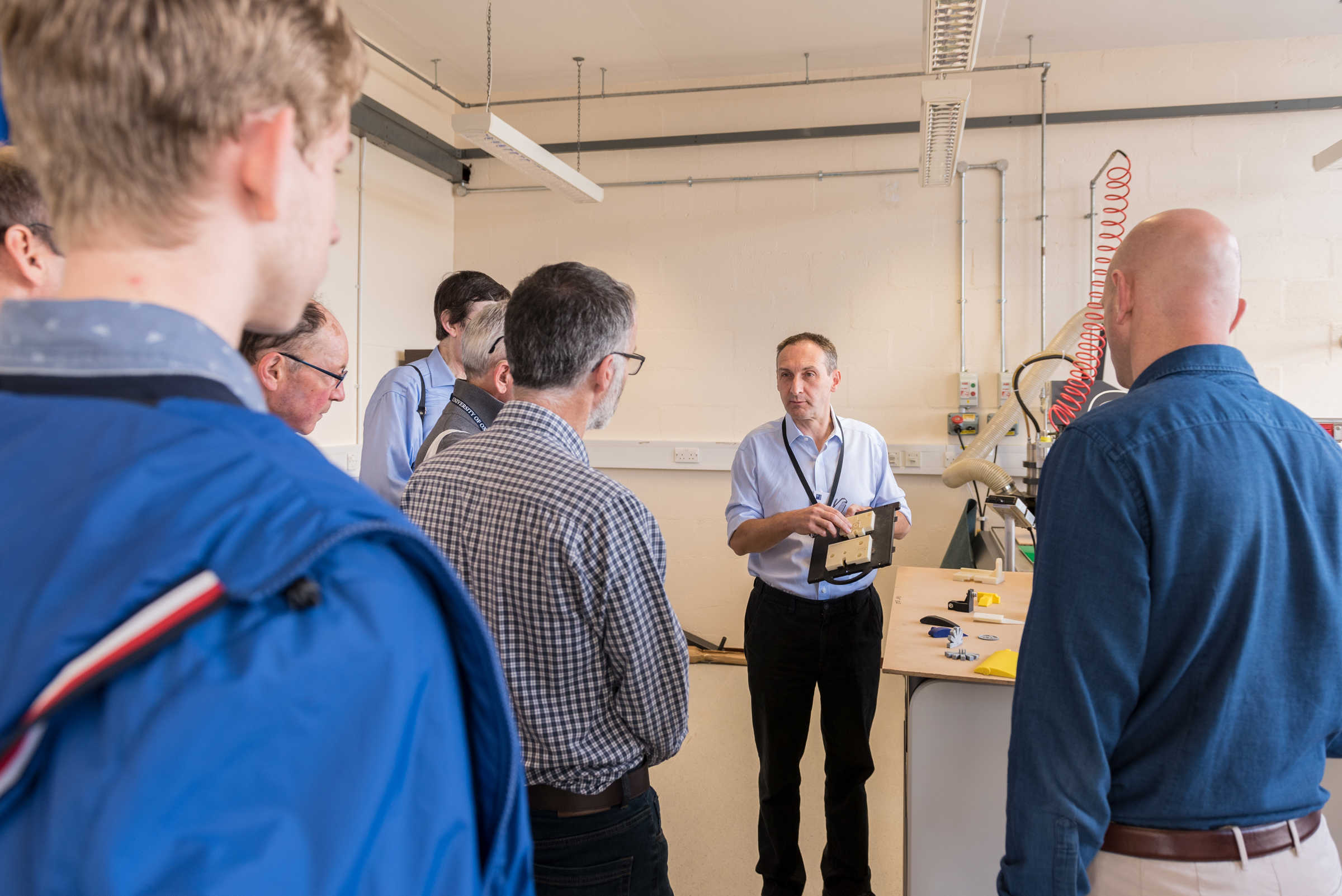 Man demonstrating to a group of people in a workshop