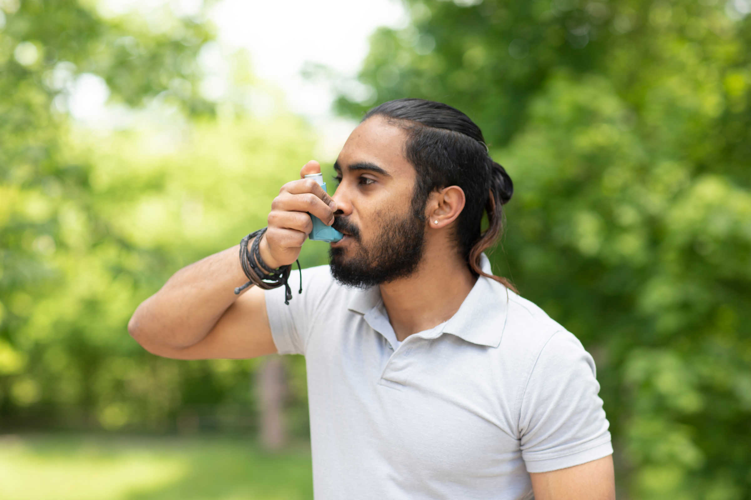 Man uses asthma inhaler 