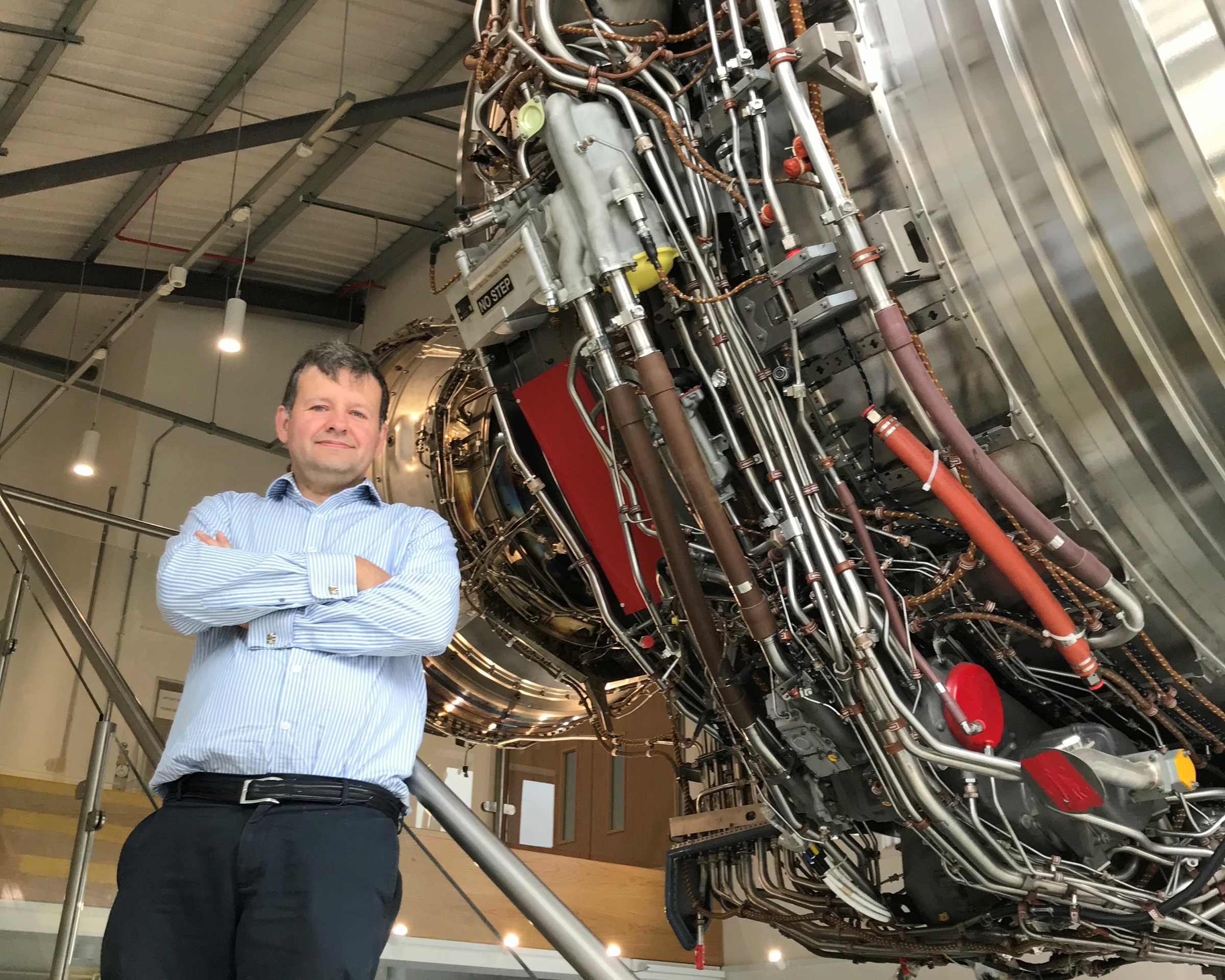 Mark Bacic in Thermofluids Institute with an aeroplane engine