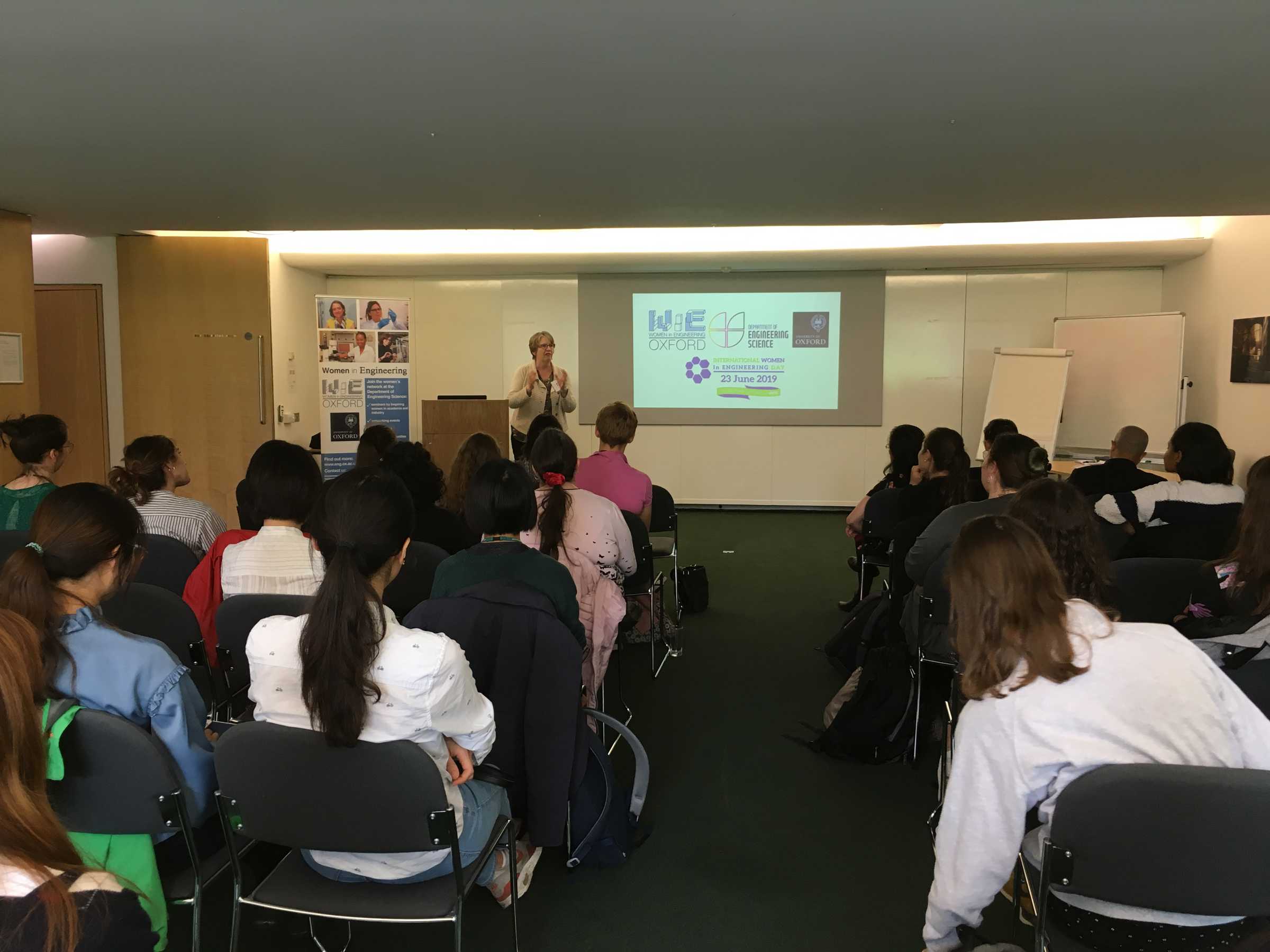 Female engineer giving a talk on International Women in Engineering Day 2019 to a room full of young students
