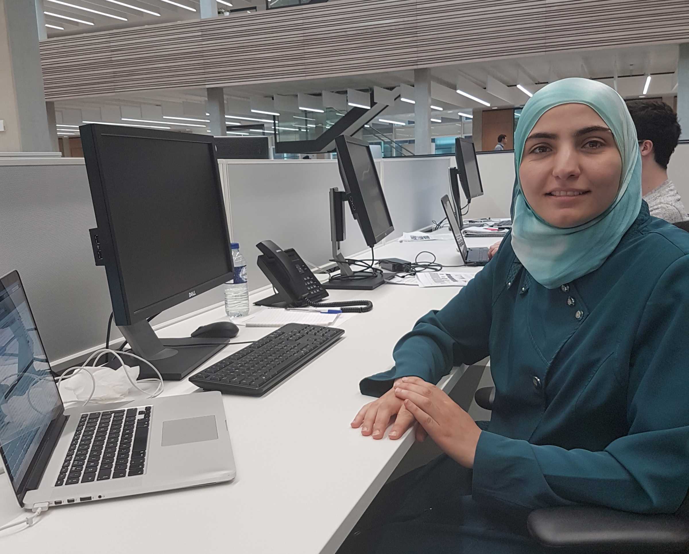 DPhil candidate Heba Sailem at her desk where she carried out research developing AI approaches to identify genetic factors that regulate the organisation of cells