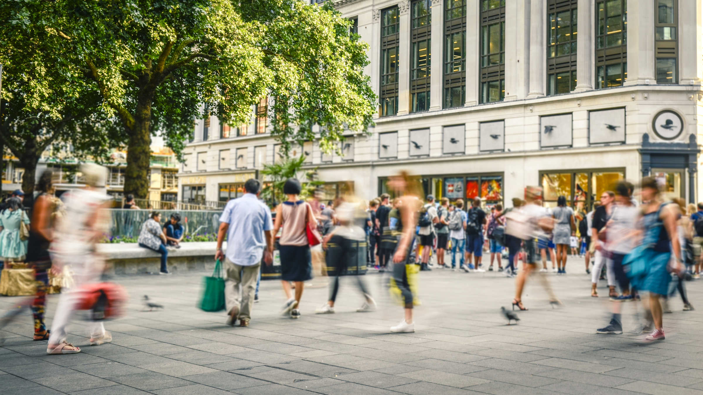 People walking around busy city