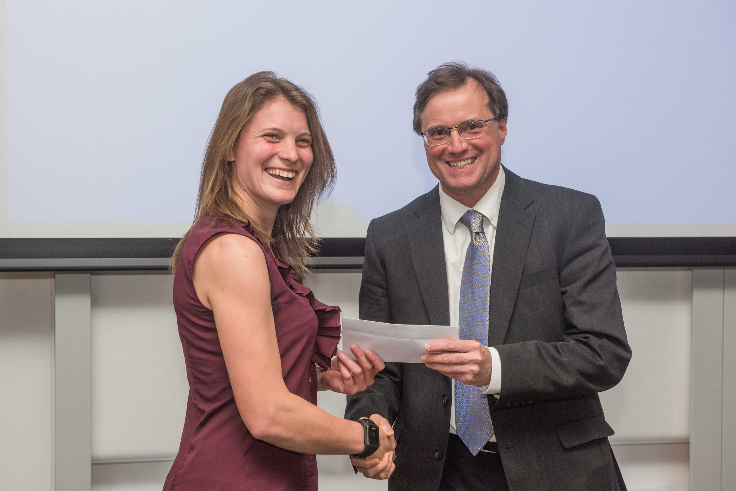 4th year student receiving her project poster prize at the lubbock lecture