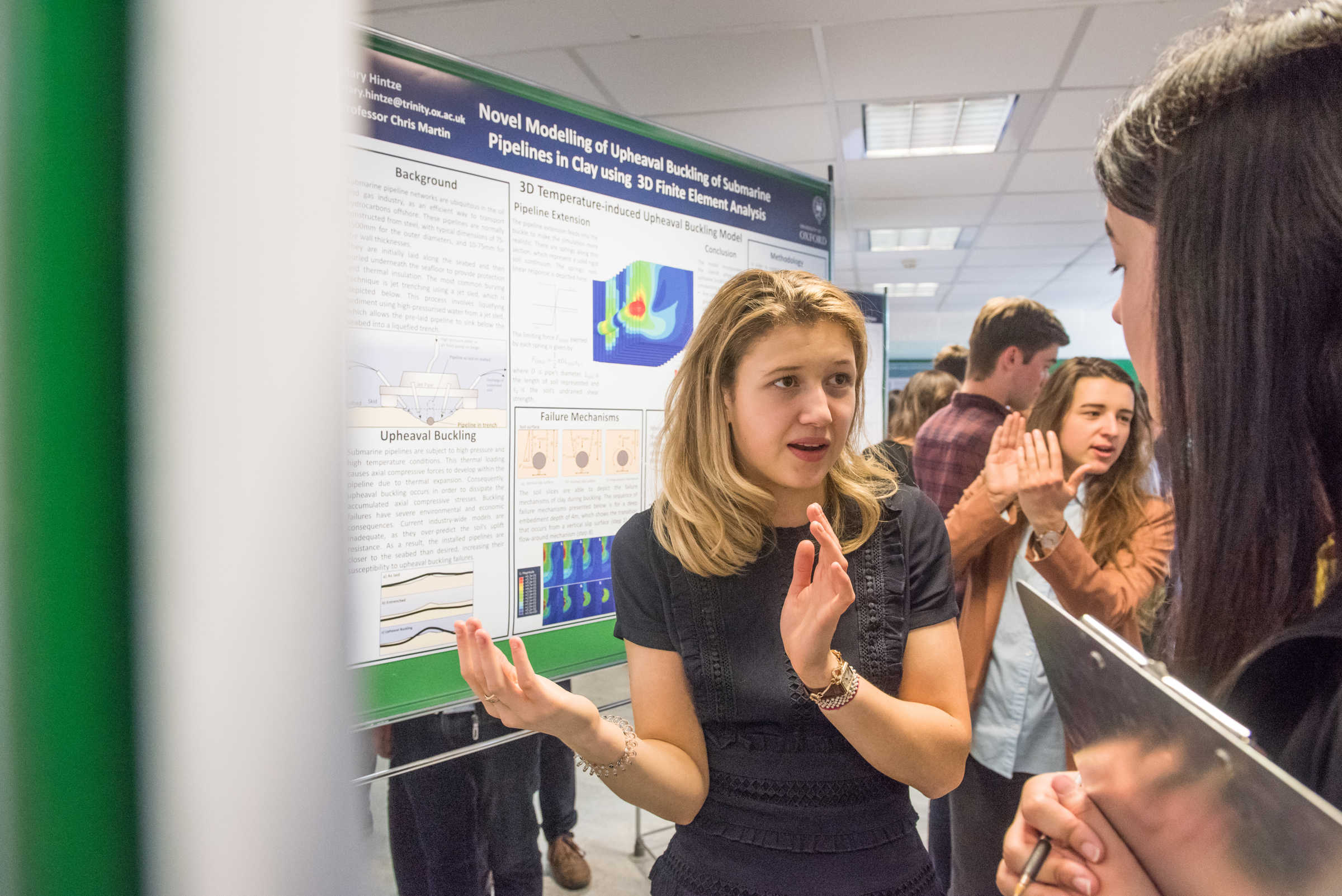 Student presenting her academic poster to public